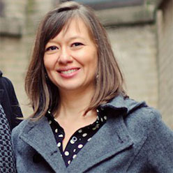 Angela is smiling.